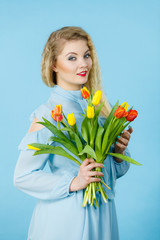Pretty woman with red yellow tulips bunch