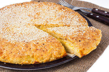 Homemade cake with cheese, sprinkled with sesame seeds