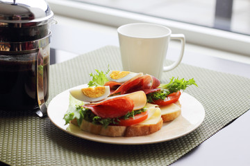 Breakfast with sandwich and coffee