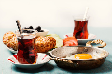 Traditional Turkish breakfast with fried eggs and tea