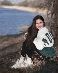 portrait of a beautiful girl on a background of a spring park