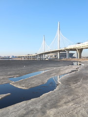 Spring in the city on the shore of the bay drift ice on the river