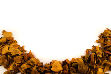 Apple dried pieces, laid in the shape of a half ring on a white background.