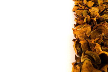 Apple dry slices stacked with a strip on the right edge of the image on a white background.