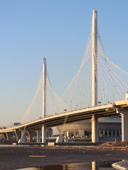 Big bridge over the river in the spring at sunset
