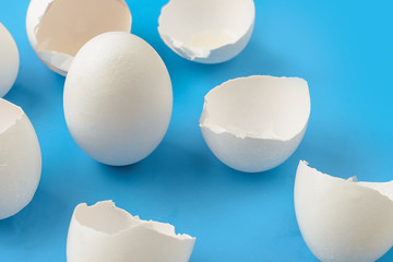 A whole chicken egg surrounded by empty eggs. The concept of infertility