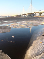 Spring in the city on the shore of the bay drift ice on the river © Andrey