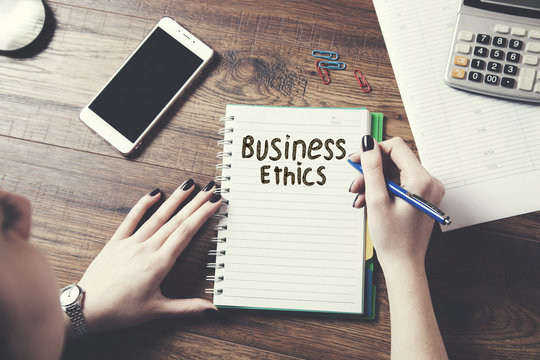 woman written business ethics text on page