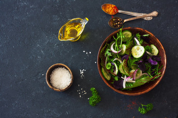 Fresh lettuce, arugula, frisee, basil, cucumber and onions salad