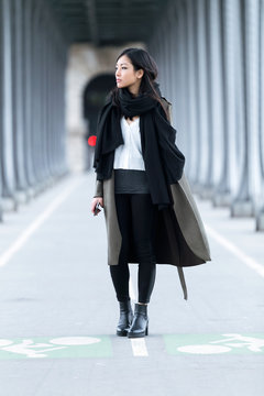 Pretty Asian Young Woman Looking Sideways In The Street.