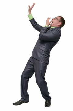 Scared businessman looks up, screams with fear and hands over his face isolated on white background. Horrified man.