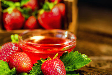 Fresh strawberries with leaves and jam close