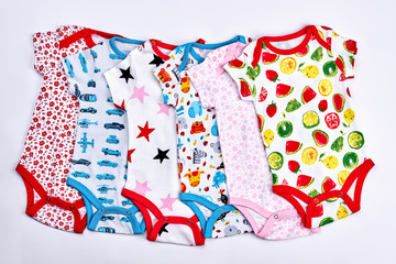 Set of kids cotton printed bodysuits. Collection of short sleeve patterned organic bodysuits for newborn babies.
