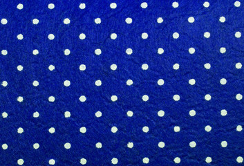 Blue polka dot felt material background.