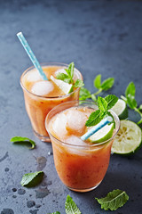 An ice-cold Peach Drink with Lime and Mint