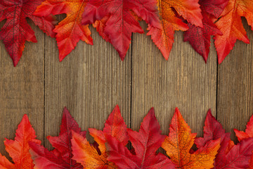 Naklejka na ściany i meble Autumn background with fall leaves on weathered wood