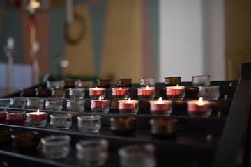 Brennende Opferkerzen in einer Kirche