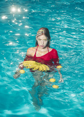 Woman relax in spa pool. Summer vacation and travel to ocean. Vitamin in banana at girl sitting near water. Dieting and healthy organic food, vegetarian. woman with tropical fruit in pool.