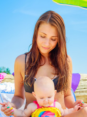 Mother and baby posing in swimsuit