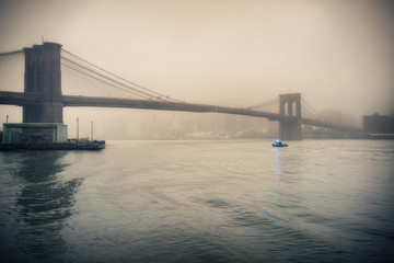 Brooklyn bridge at foggy rainy evening, New York City