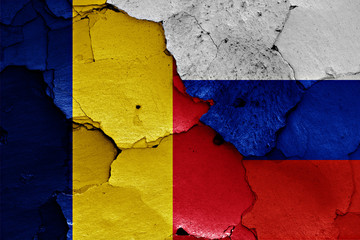 flags of Romania and Russia painted on cracked wall