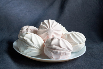 white and pink zephyr close-up on a white plate