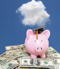 piggy bank cash with graduation cap and blue sky