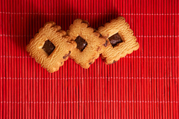 Chocolate cookies on gray plate on wooden table, closeup.