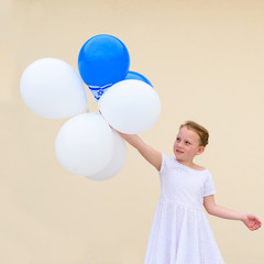 Fototapeta na wymiar Happy kid, cute little blonde jewish girl with blue and white balloons and Israel flag.Patriotic holiday Independence day Israel - Yom Ha'atzmaut concept.