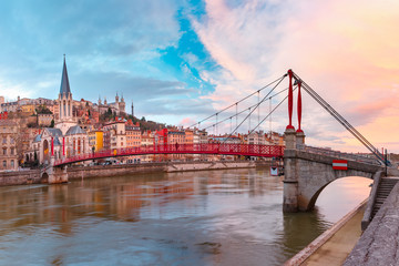 Fototapeta na wymiar Saint Georges church and footbridge across Saone river, Old town with Fourviere cathedral at gorgeous sunset in Lyon, France