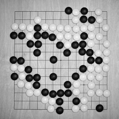 Go East game view from the top. Traditional Chinese game. board "goban" with black and white stones. A tree lined with stripes squares intersection of strips. «I-go» «Go» game