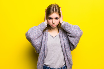 Emotional stress. Depressed girl keeping eyes closed and covering ears with hands. Don't hear....