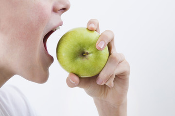 mouth biting the apple with white space