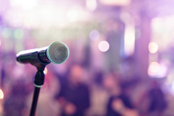 Plakat Close up microphone on stage in concert hall restaurant or conference room. Blurred background. Copy space