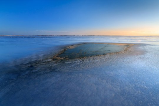 spot dawn on a frozen lake / icy landscape Ukraine winter
