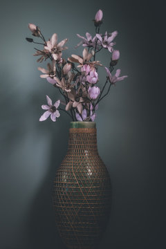 Still-life of flowers in a vase with a green/blue background creating a abstract image