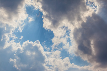 Big white cumulus cloud against blue sky