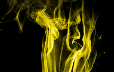 Fototapeta premium Yellow smoke on black background