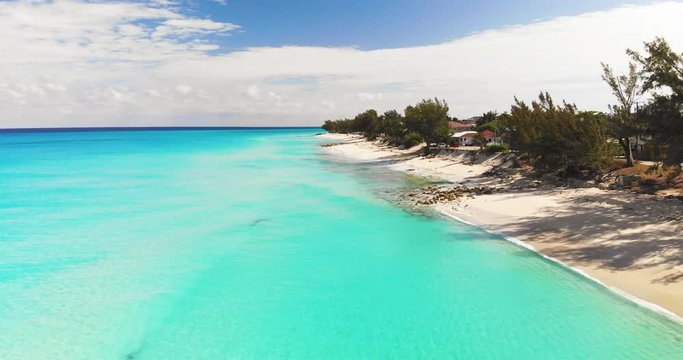 Aerial view of a desert island with a clear and transparent sea and a pristine beach. Concept of: holidays, maldives, dream landscapes.