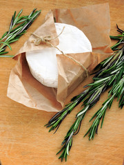 Camembert in paper and fresh rosemary