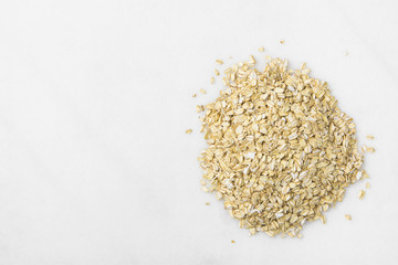 Heap of Rolled Oats Spilled on White Marble Stone Table. Healthy Lifestyle Nutrition Fiber Source Concept. Poster Banner Streamer with Copy Spac