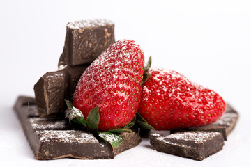 Strawberries on chocolate, white background.