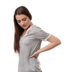 Fototapeta premium Young woman suffering from back pain on white background