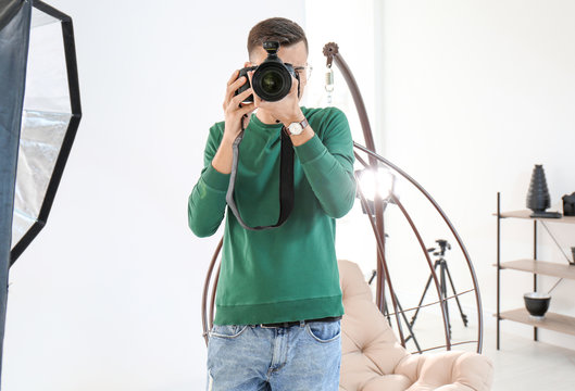 Young photographer working in professional studio