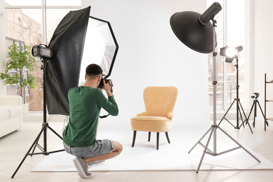 Young photographer working in professional studio