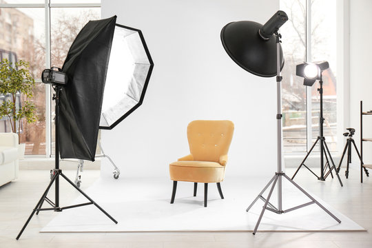 Armchair in photo studio with professional equipment