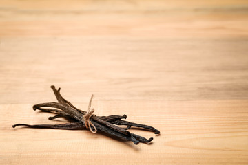 Aromatic vanilla sticks on wooden background
