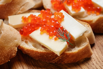 Delicious sandwich with red caviar, closeup