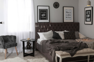 Stylish room interior with comfortable bed