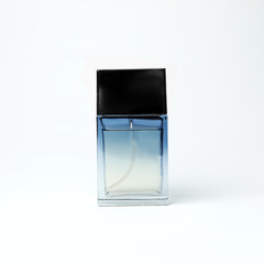 Transparent bottle of perfume on white background